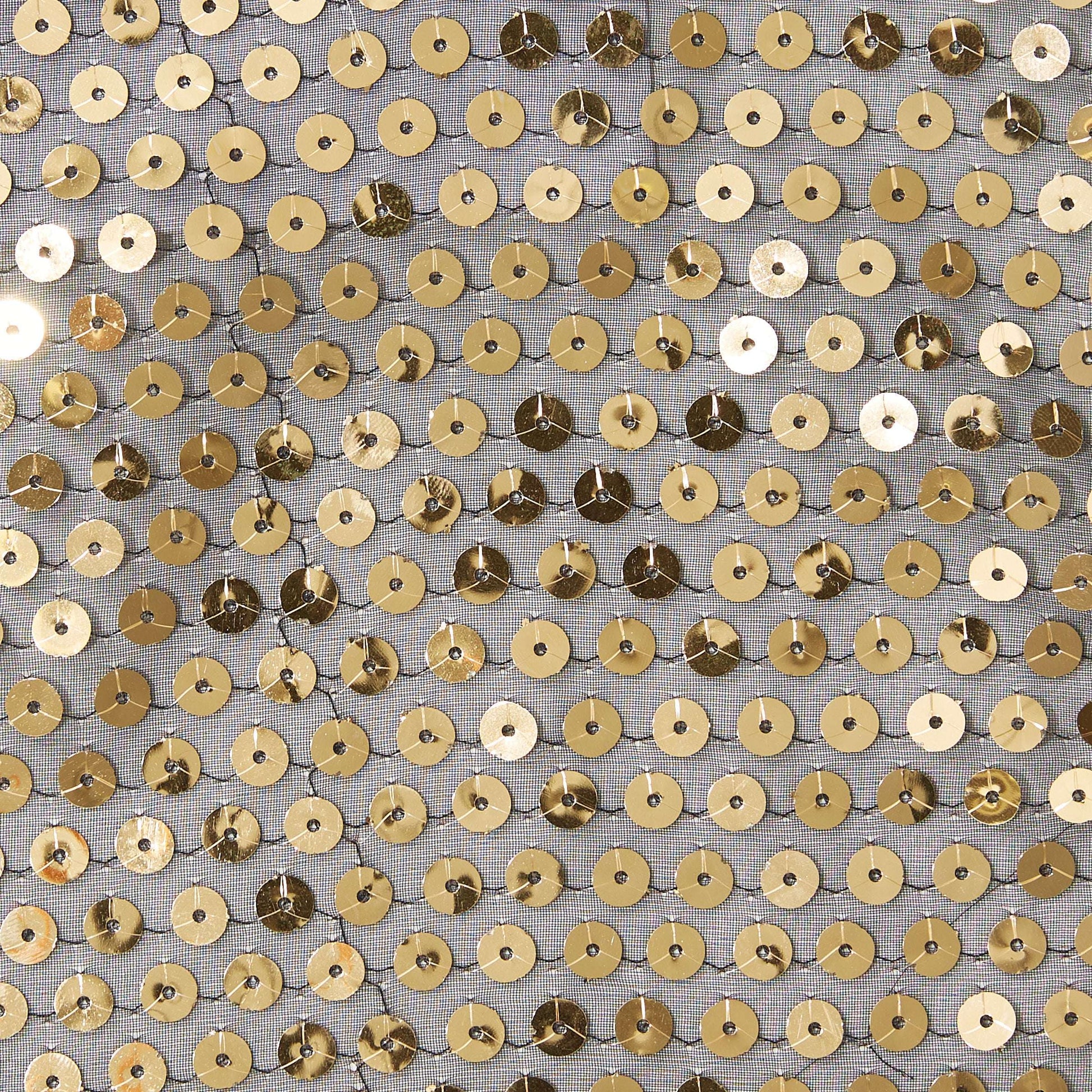 Showing sequin georgette featuring Gold colored sequins on sheer georgette polyester black mesh with good drape