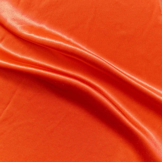 Silk Satin showing the  lava color version of a soft pure mulberry silk satin with natural sheen and fluid drape