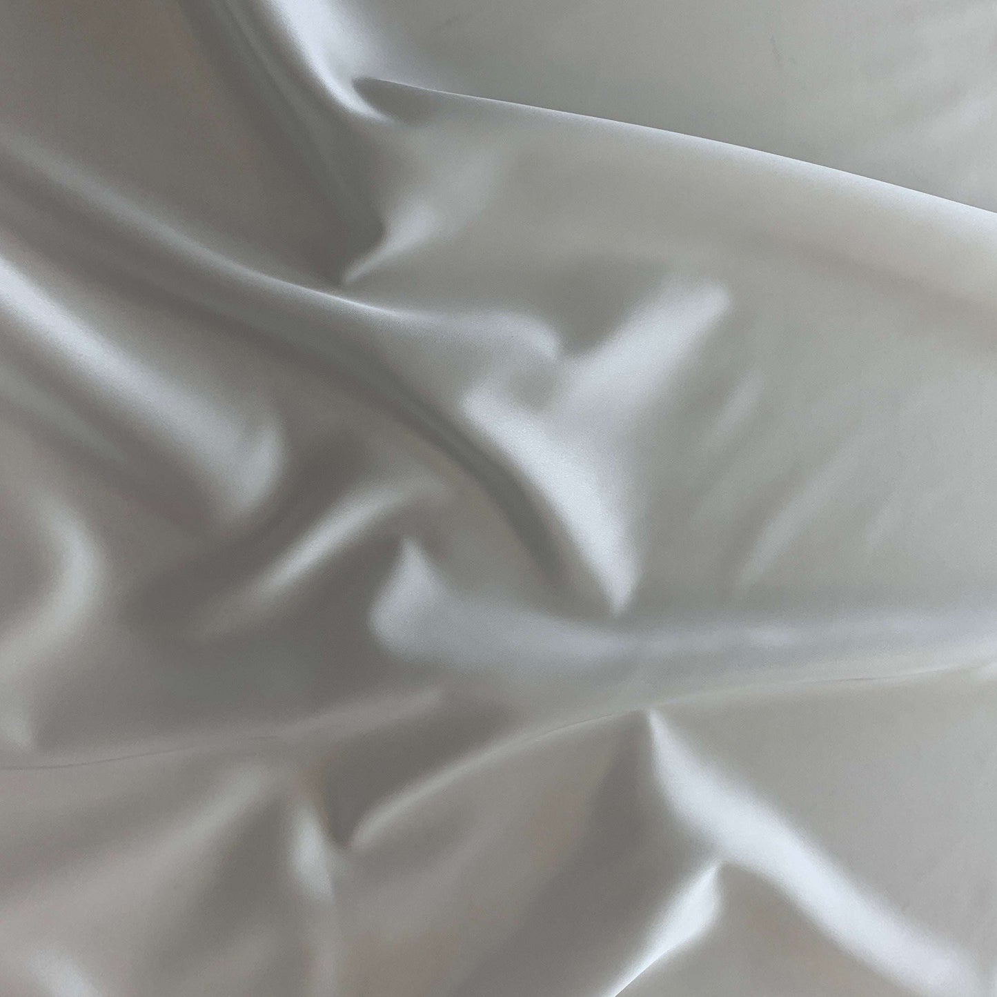 Showing Stella heavy stretch satin a ivory colored polyester Microfiber and Spandex blended fabric