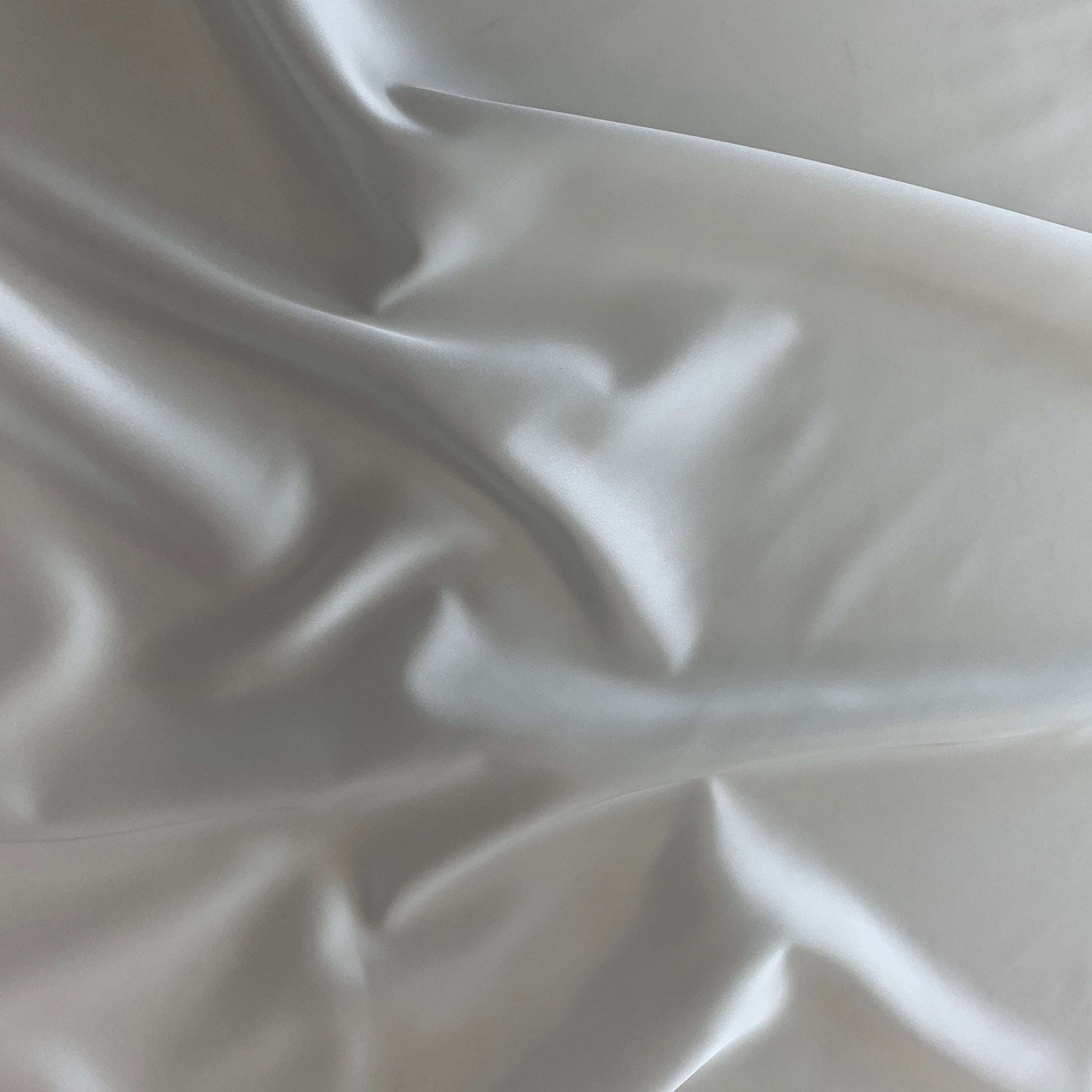 Showing Stella heavy stretch satin a ivory colored polyester Microfiber and Spandex blended fabric
