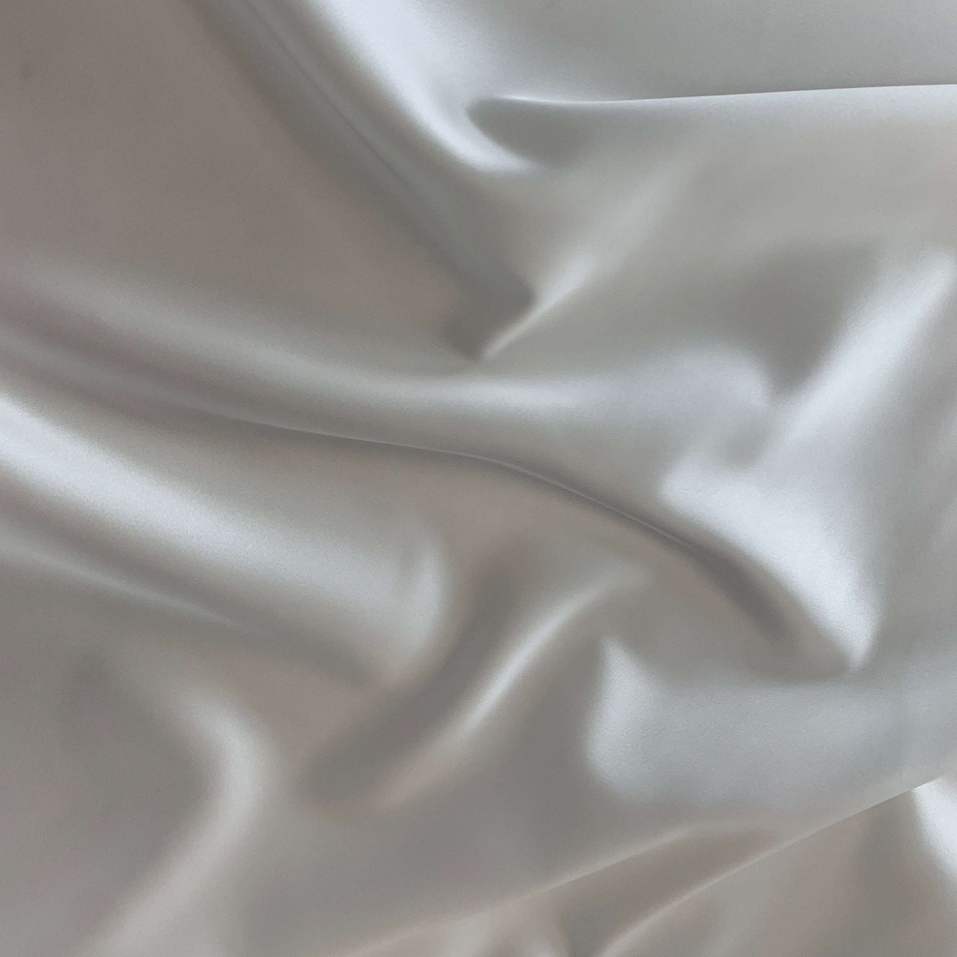 Showing Stella heavy stretch satin a ivory colored polyester Microfiber and Spandex blended fabric