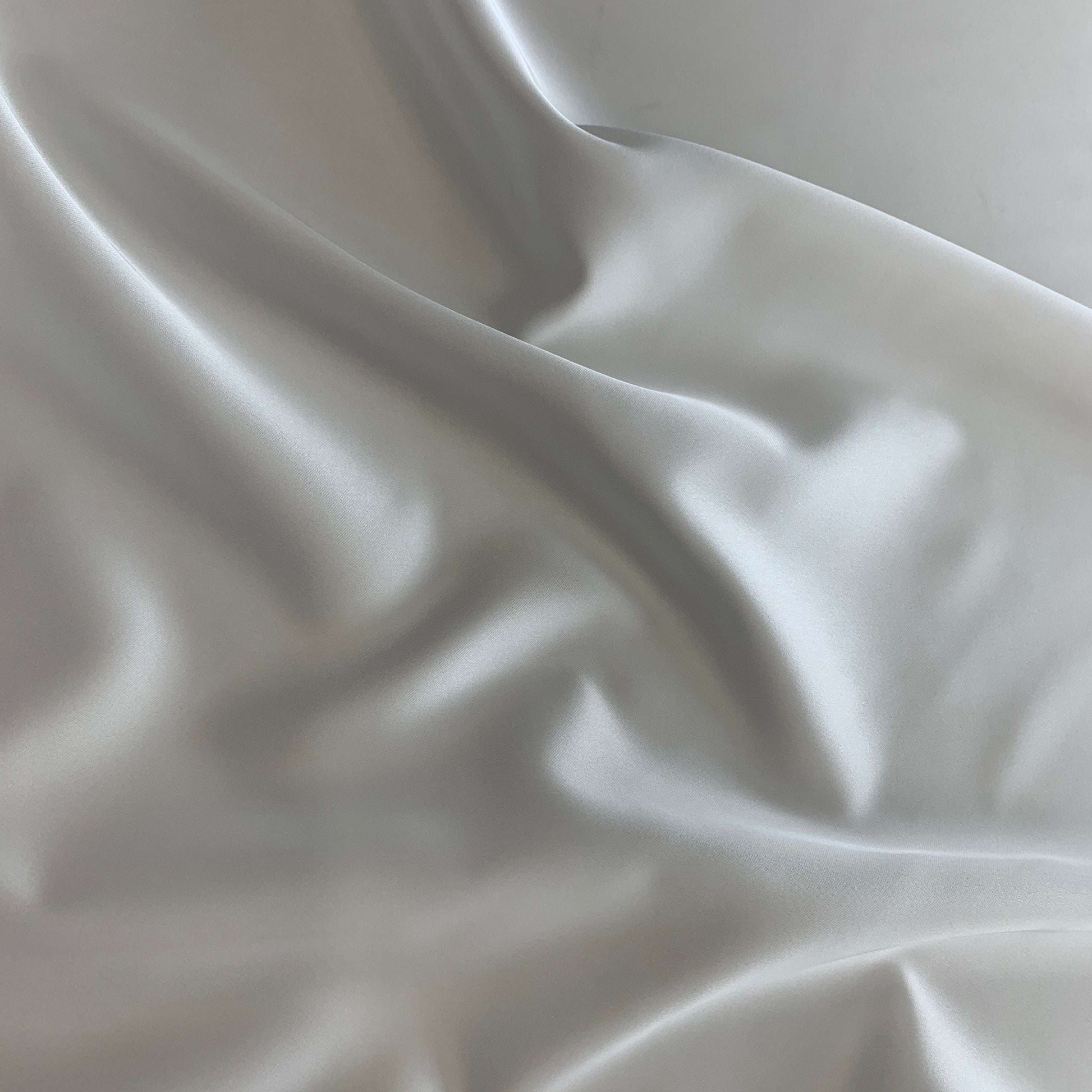 Displaying Stella heavy stretch satin a ivory colored polyester Microfiber and Spandex blended fabric