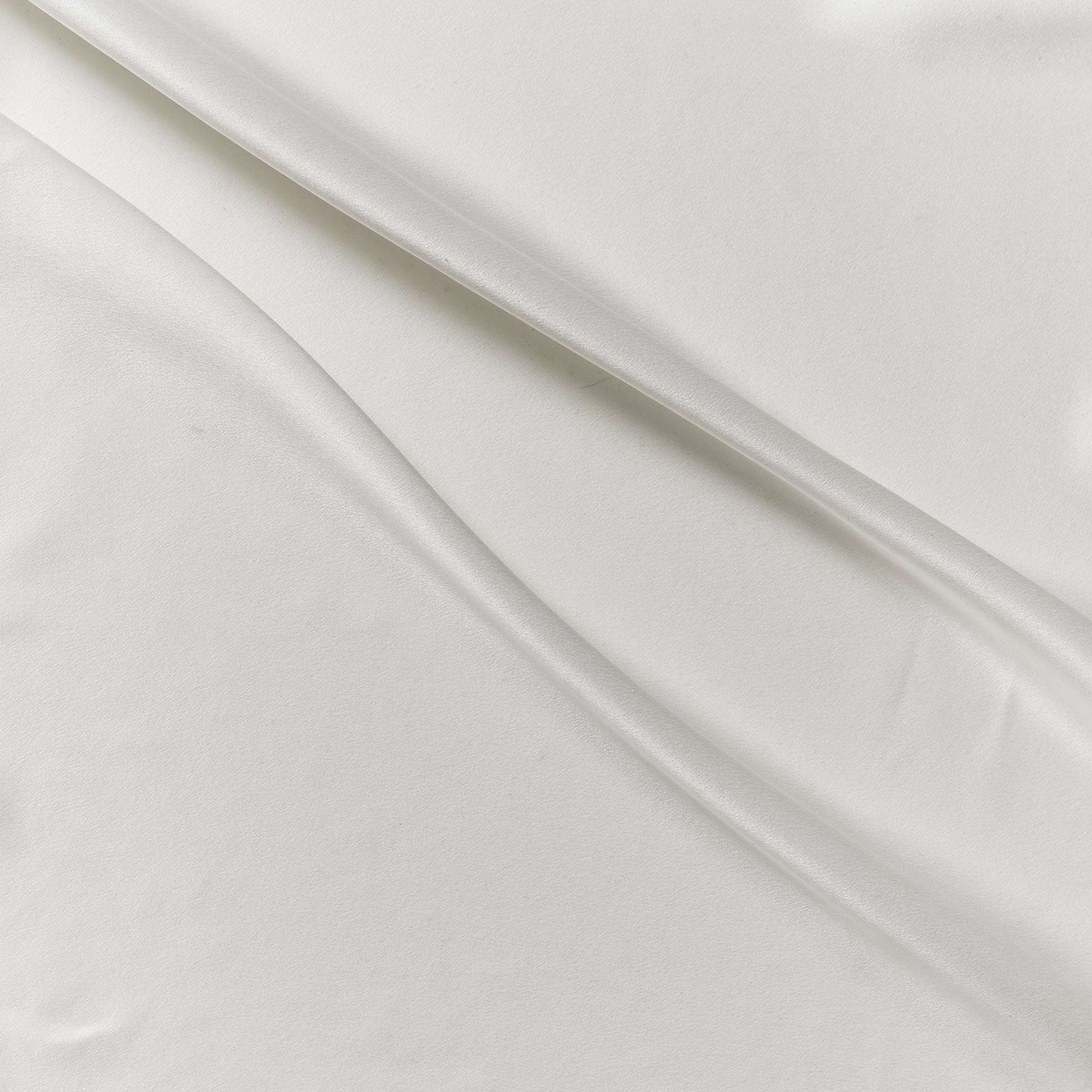 supremo showing the ivory color version of a sand washed soft delustered pure silk with fluid drape