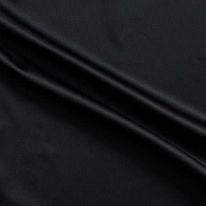 Trump showing the black color version of a stretch duchess satin polyester and lycra blend with a delustered smooth sateen finish and gutsy weight