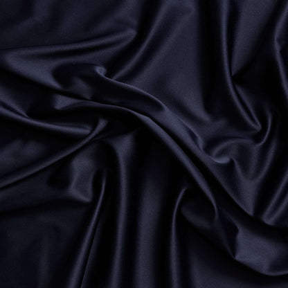 Trump showing the ink color version of a stretch duchess satin polyester and lycra blend with a delustered smooth sateen finish and gutsy weight