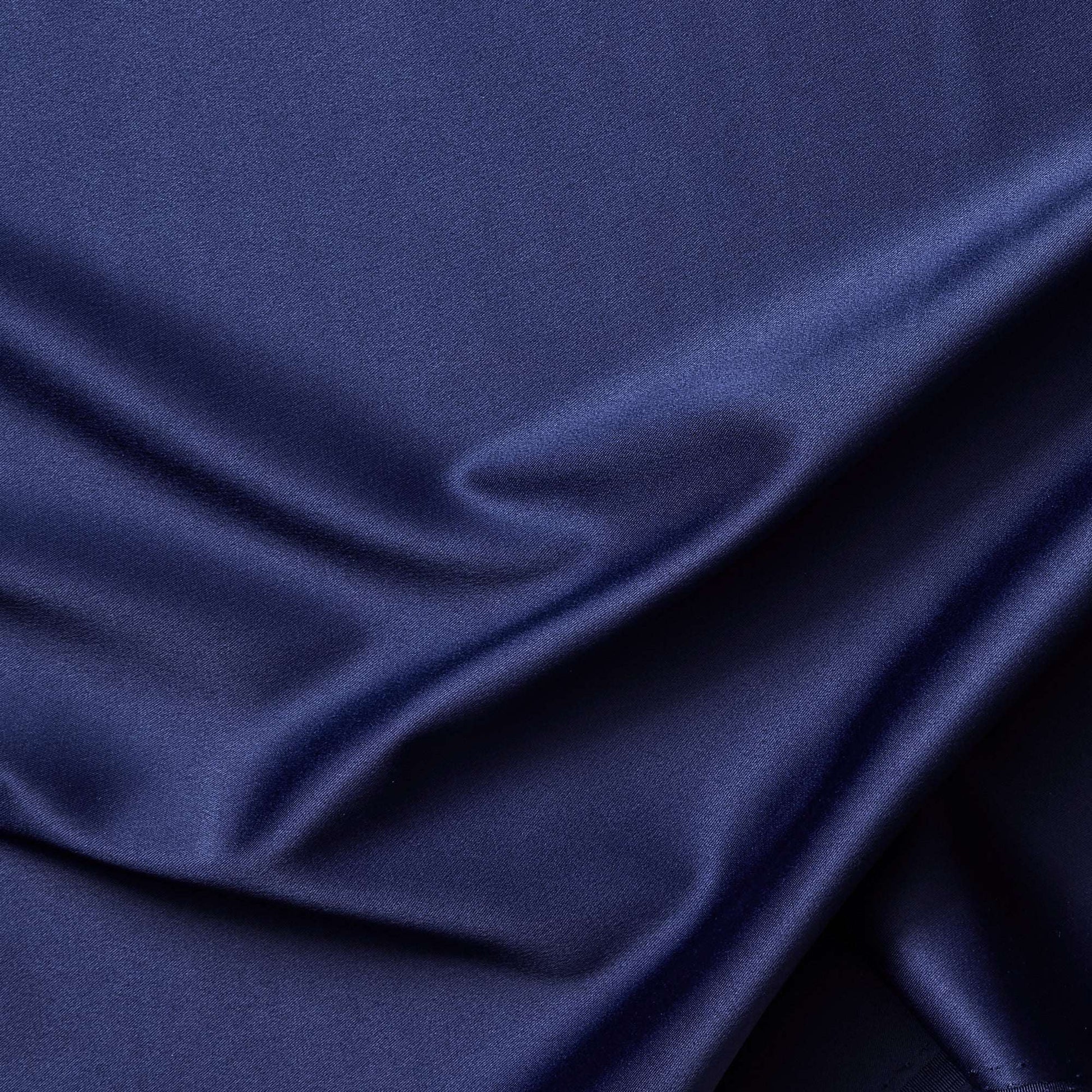 Trump showing a closeup of the midnight color version of a stretch duchess satin polyester and lycra blend with a delustered smooth sateen finish and gutsy weight