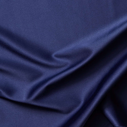 Trump showing a closeup of the midnight color version of a stretch duchess satin polyester and lycra blend with a delustered smooth sateen finish and gutsy weight