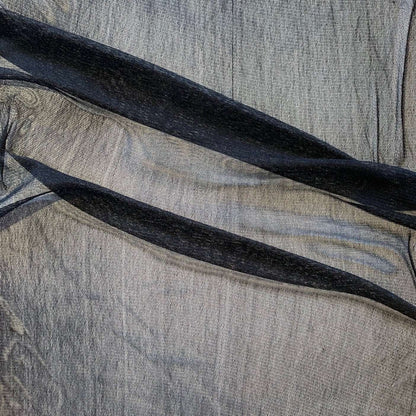 vapour showing the black color variant of a soft sheer breathable light weight matte pure silk tulle featuring natural silk sheen