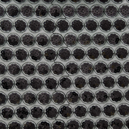 Showing vegas a black colored Sequinned embroidery in regurlar spots on a sheer black polyester mesh  base