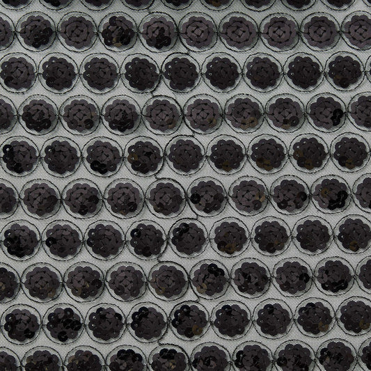 Showing vegas a black colored Sequinned embroidery in regurlar spots on a sheer black polyester mesh  base