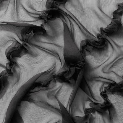 cascade displaying the black colored version crinkle light weight sheer pure silk chiffon with diagonal ruffle flounce 