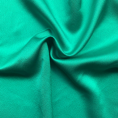 Celebrity showing the the Kelly Color Version of a satin backed crepe polyester microfiber with fluid drape