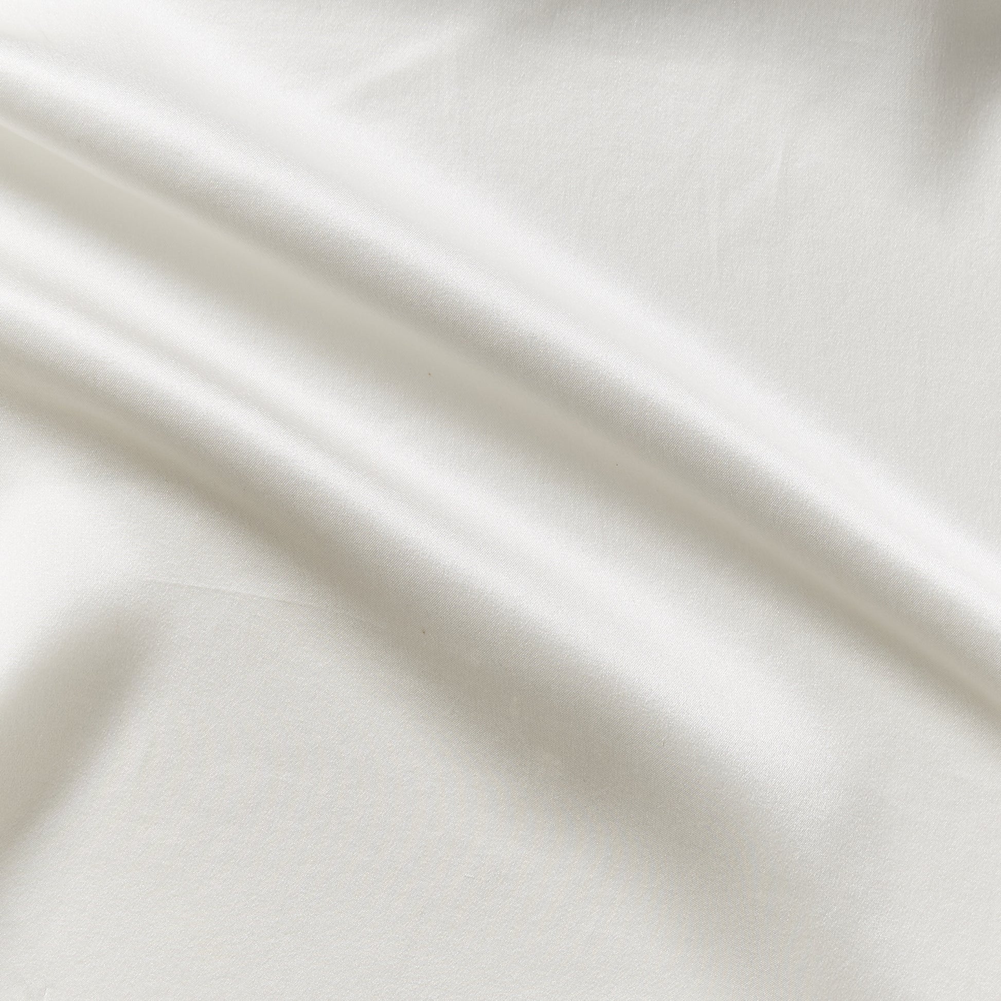 Displaying charmeuse a natural colored pure light weight silk with satin lustre and fluid drape featuring a wide width