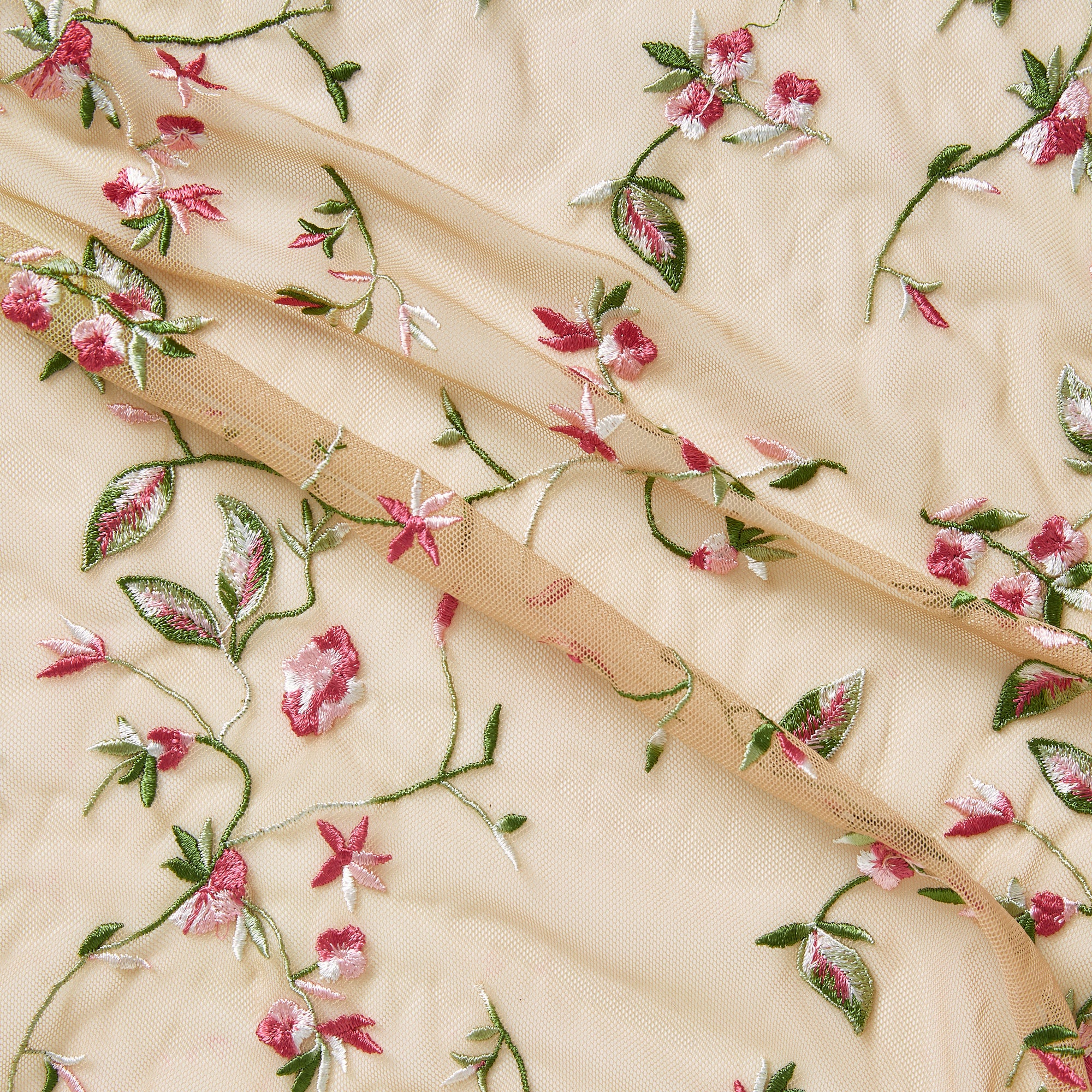 cherish demonstrating the beige base color version featuring a nylon delicate floral vine embroidery on nude rayon mesh