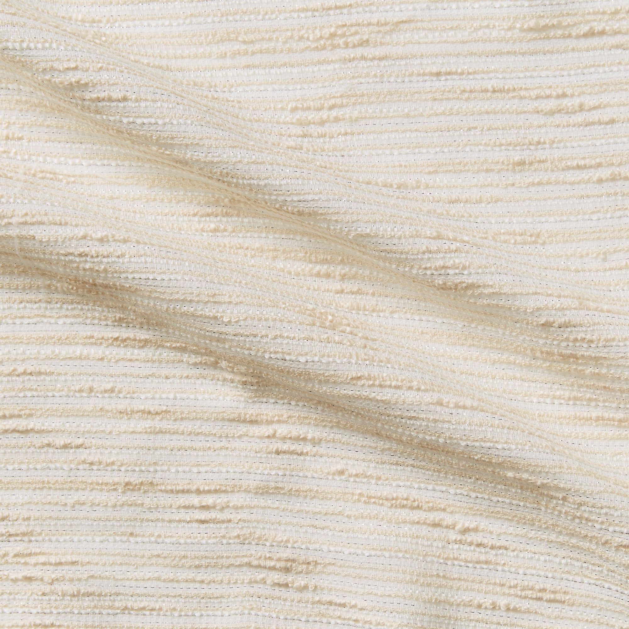 coco presenting the cream color version of a polyester cotton blend bouclé fabric with lurex thread 