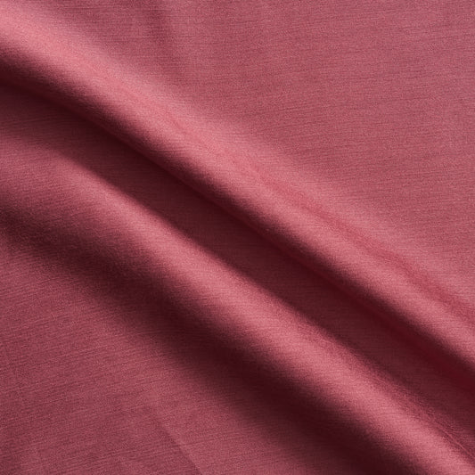 Corisia displaying the rose color version of a soft silk viscose and cotton blend with natural silk sheen medium softness and moderate drape