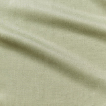 cruise displaying the fern color version of a lightweight linen and polyester blend with subtle sheen and moisture wicking properties