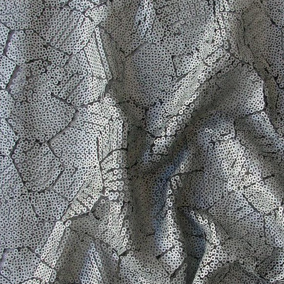 Displaying Clash which features silver colored Sequins in a abstract design on Black pure Polyester Mesh 