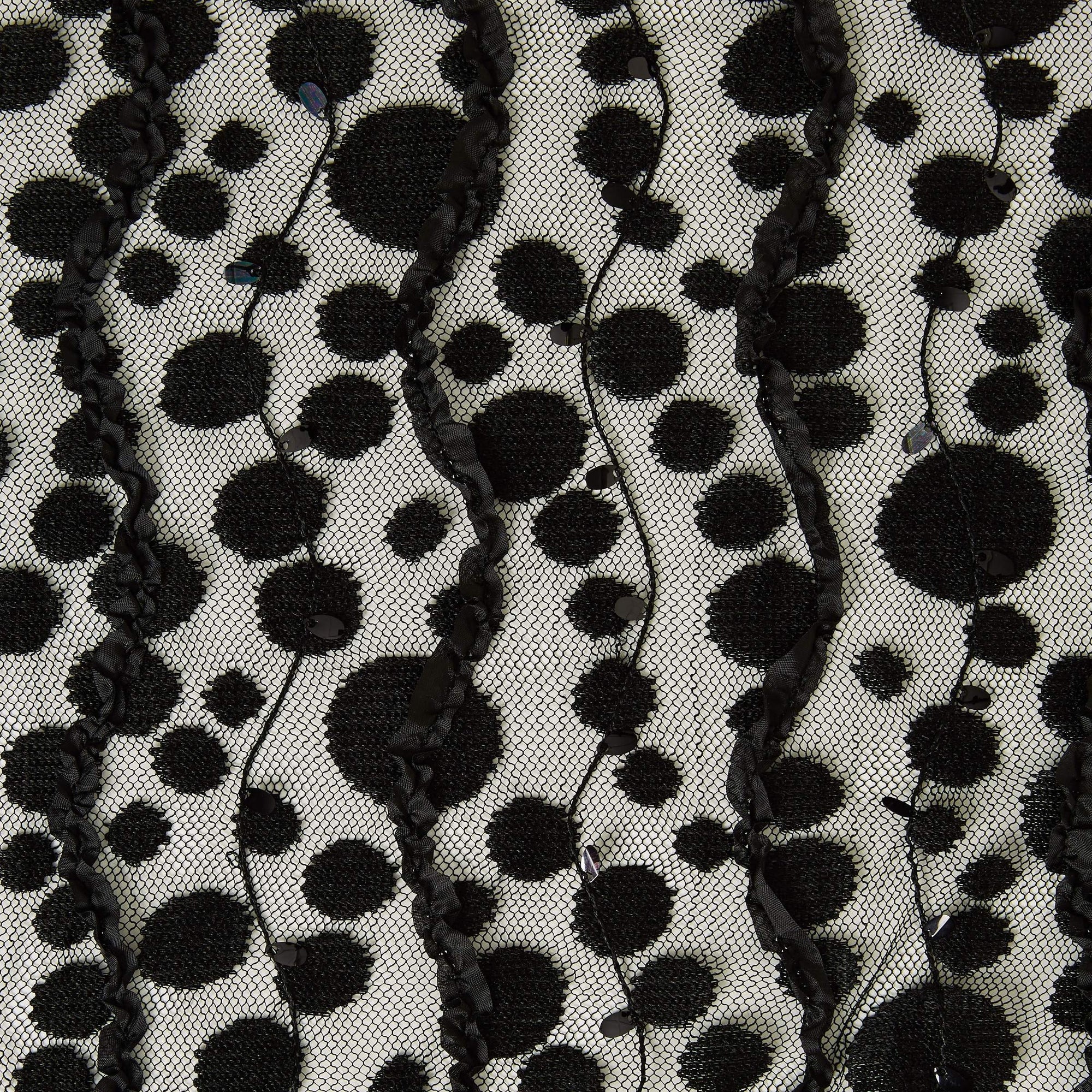 Dazzle displaying a fabric featuring black spots and ribbon embroidered on black colored mesh as a polyester and nylon blend