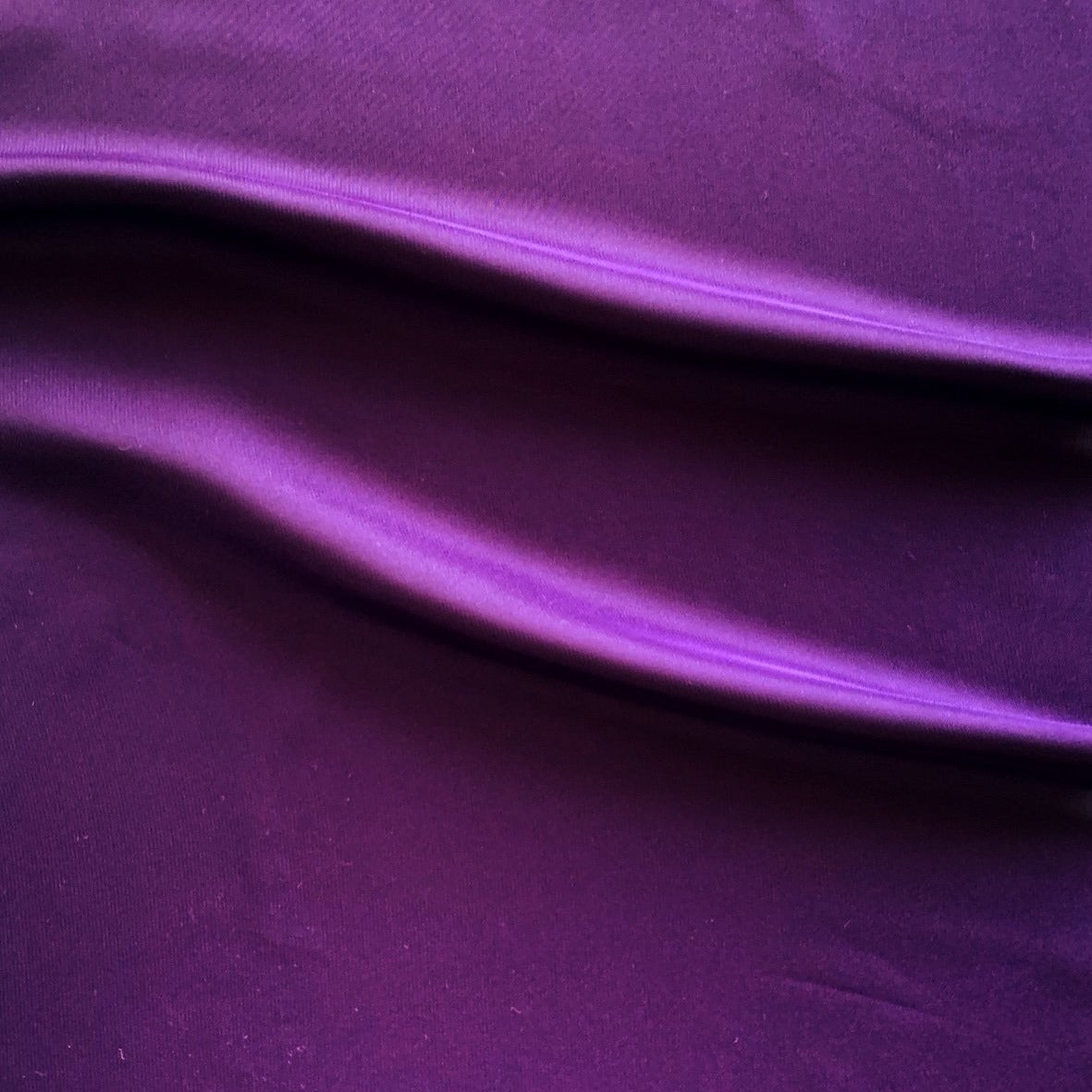 Deluxe displaying the violet color version of a satin chiffon silk like pure polyester with fluid drape