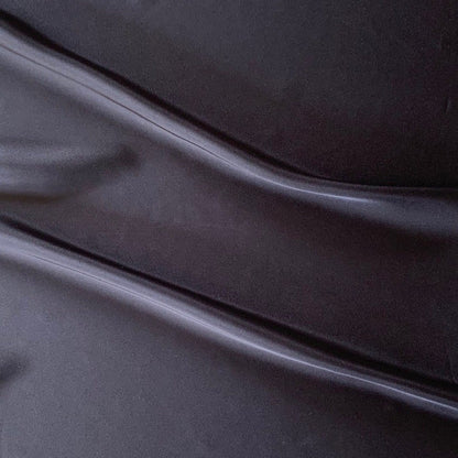 Deluxe displaying the charcoal color version of a satin chiffon silk like pure polyester with fluid drape