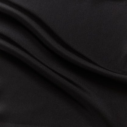 Eternity displaying the black color version of a heavy weight pure mulberry silk satin with fluid drape