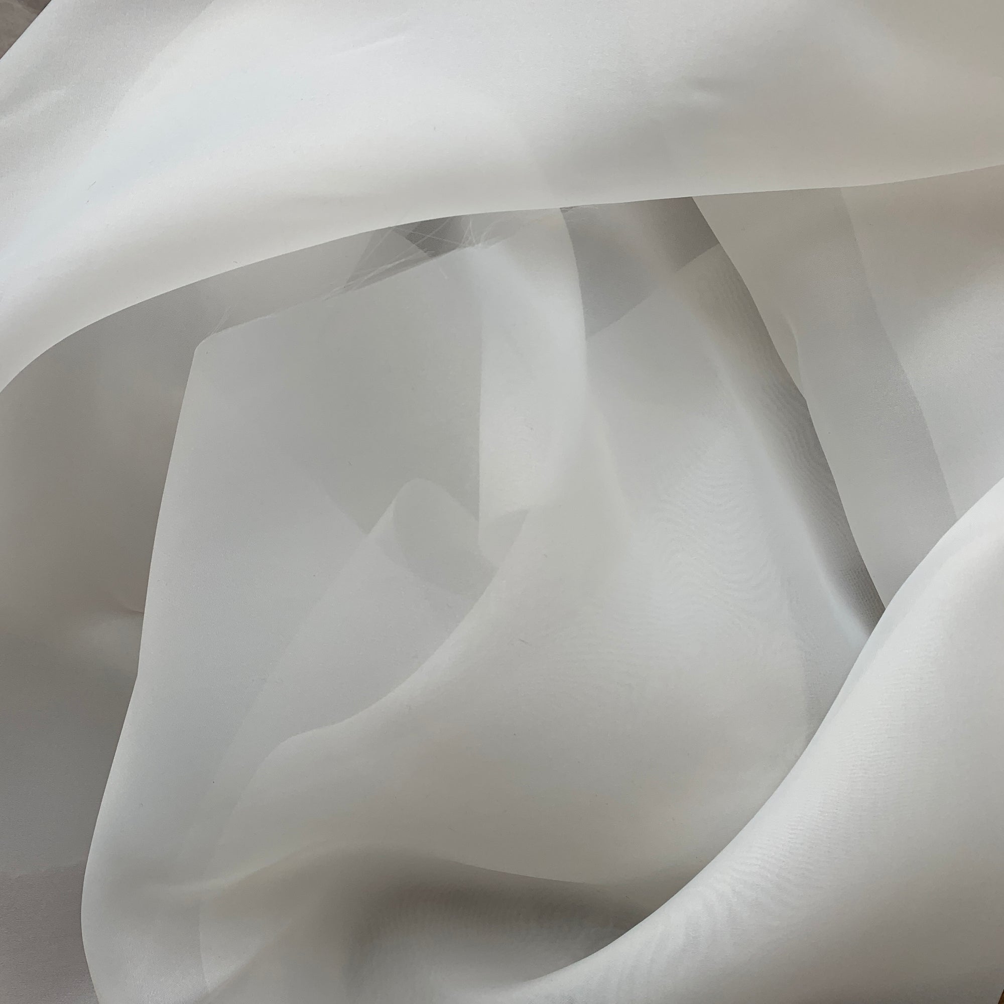 Illustrating Gazar Satin Organza a ivory colored lustrous poly organza with a soft hand-feel