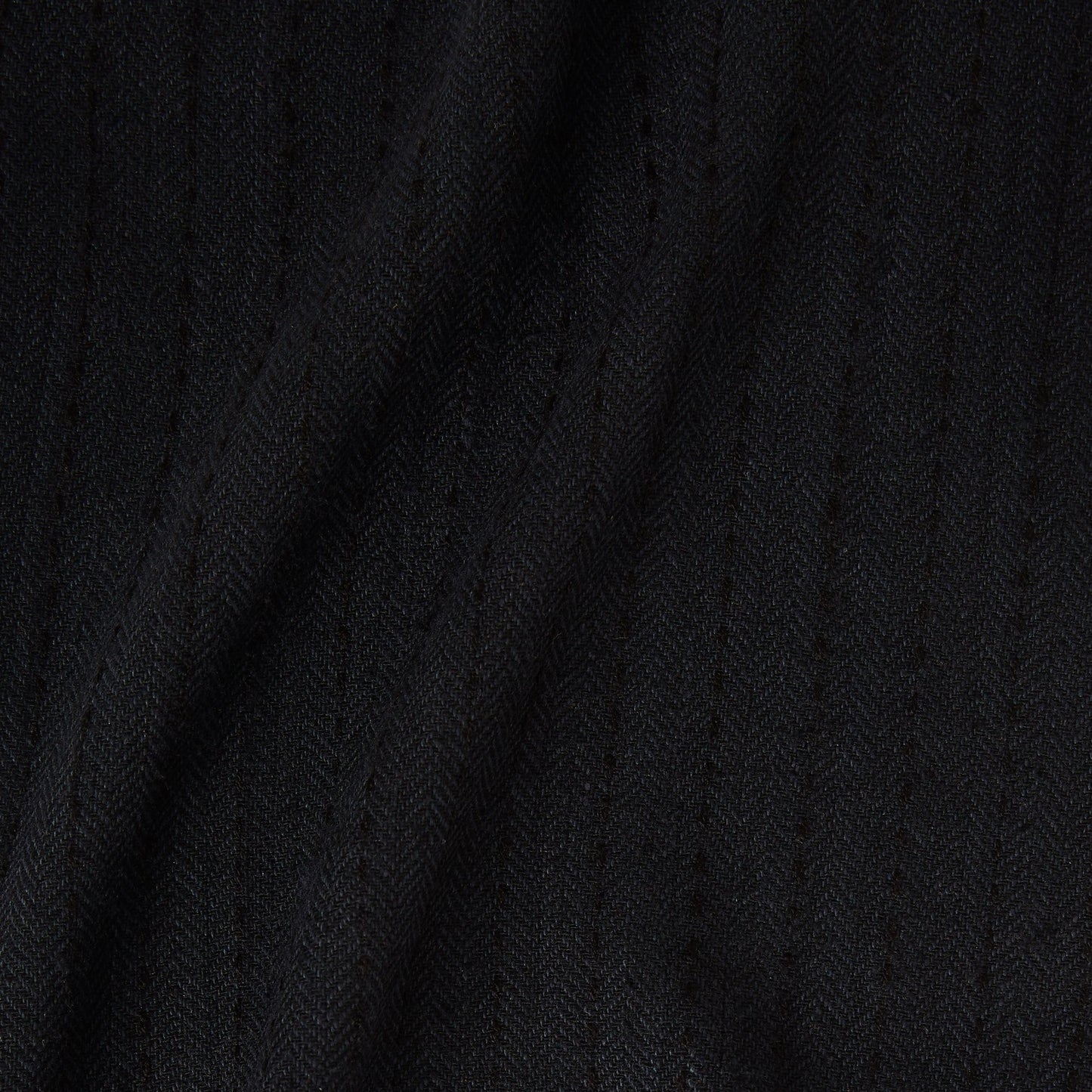 Displaying herringbone a black colored classic patterned all natural viscose and wool blend folds