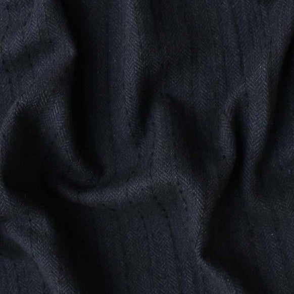 Displaying herringbone a black colored classic patterned viscose and natural wool blend closeup