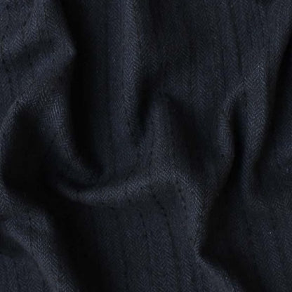 Displaying herringbone a black colored classic patterned viscose and natural wool blend closeup