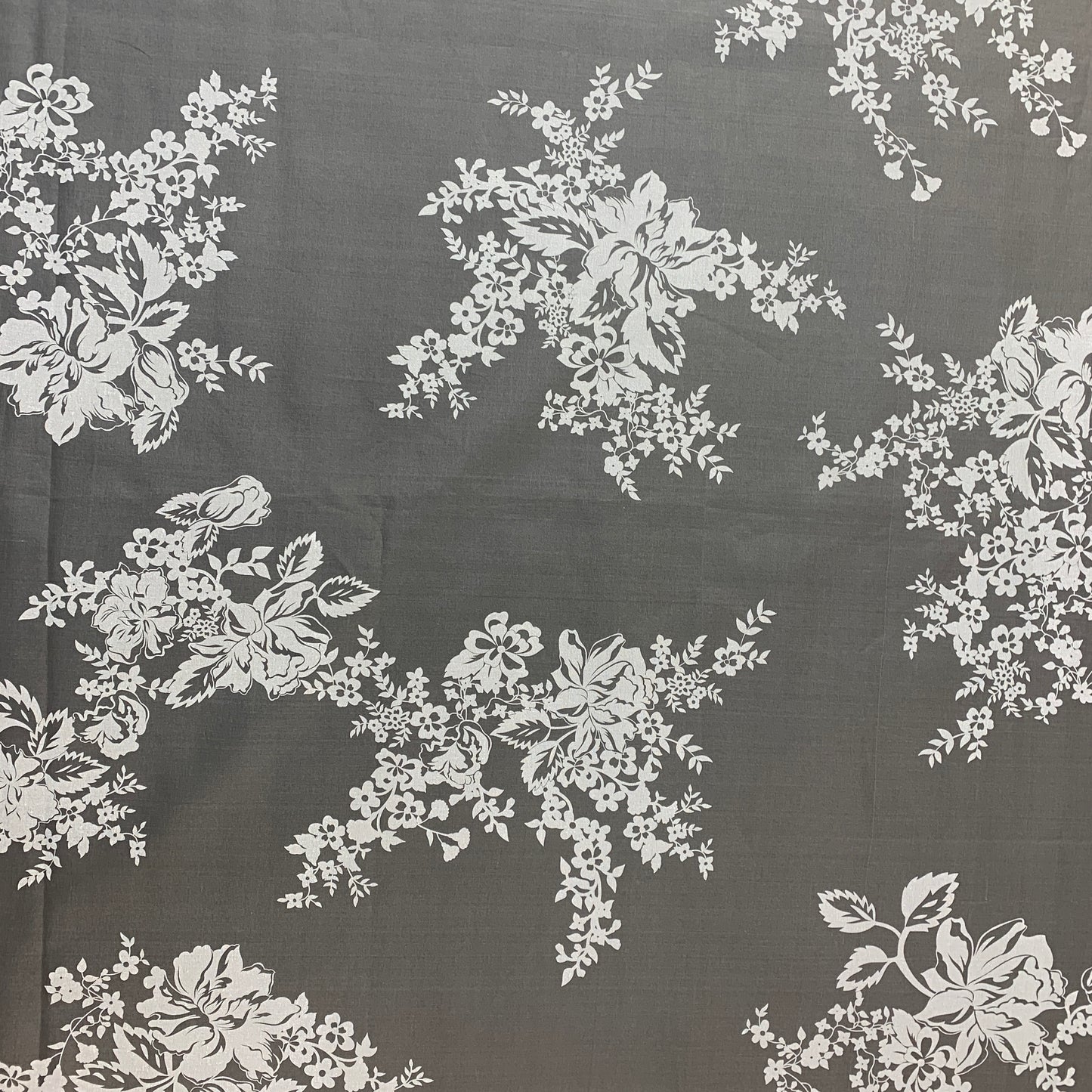 Showing rhapsody which is a white floral print on sheer ivory pure silk organza shown flat