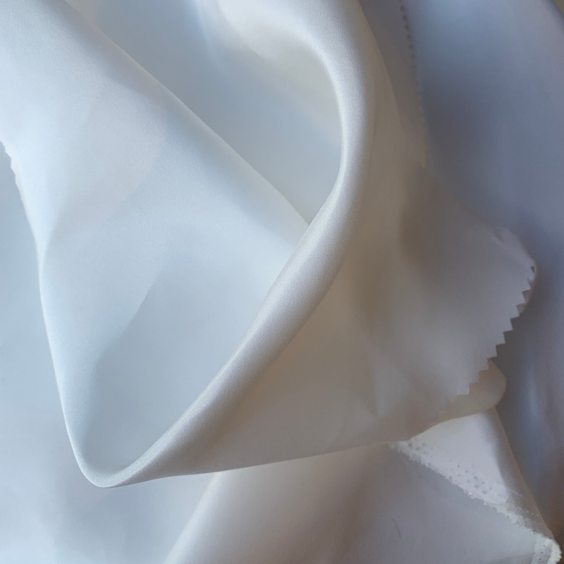 silk taffeta showing the natural color version of a smooth crisp pure silk with good drape with good drape