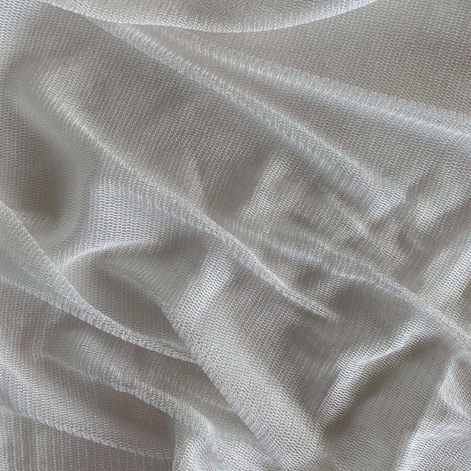 vapour illustrating the natural color variant of a soft sheer breathable light weight matte pure silk tulle with natural silk sheen