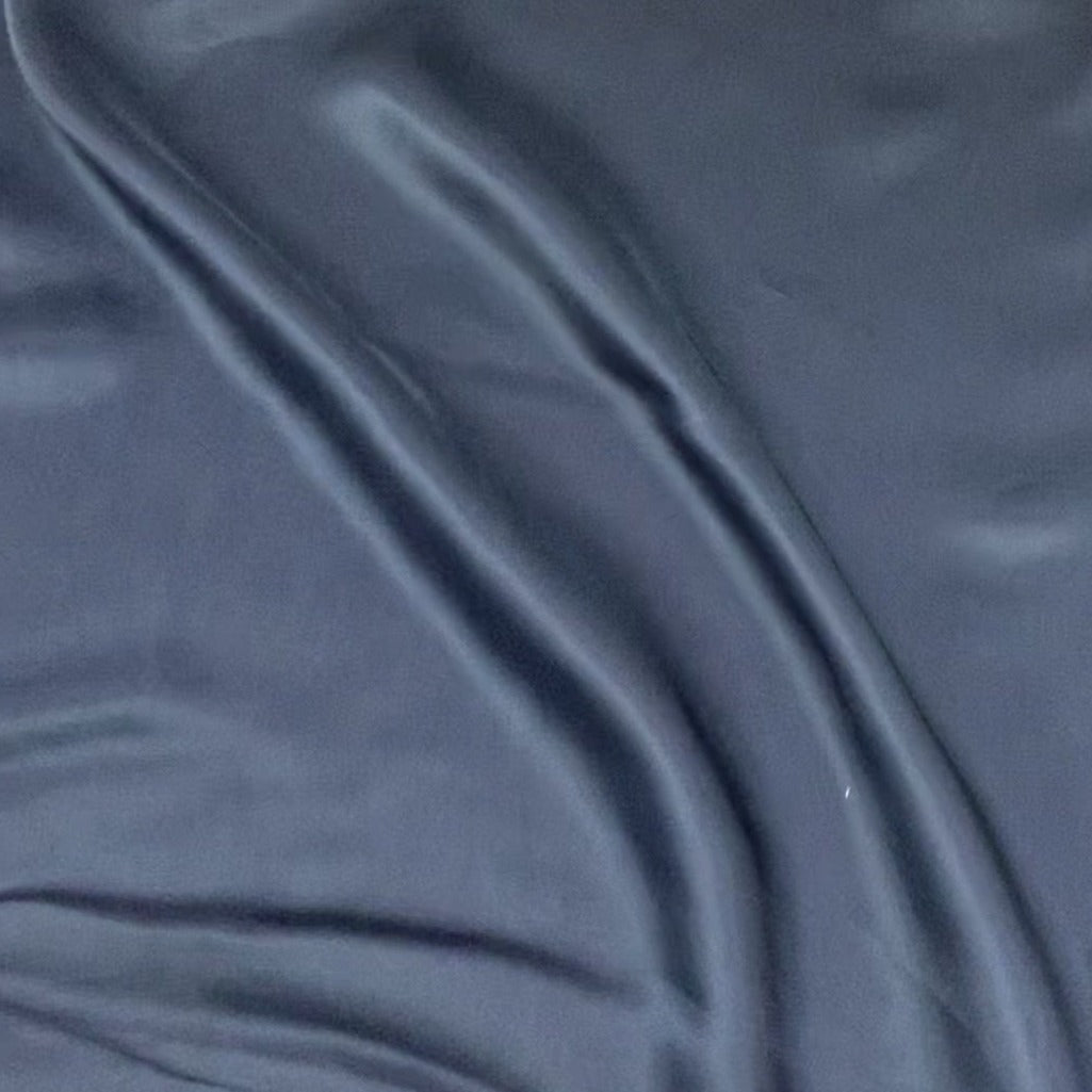 saga presenting the navy color version of a pure rayon Fine twill satin with fluid drape