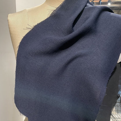 ultima displaying the navy color version of a polyester and acetate blend semi sheer mid weight textured fabric with fluid drape