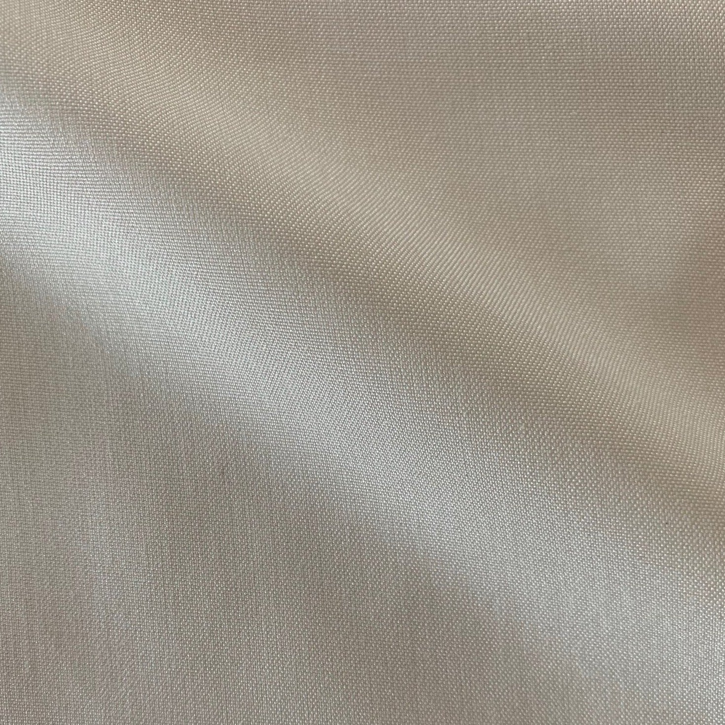 Showing double fuji a natural colored silk fabric with breathable light weight pure spun silk shirting in closeup