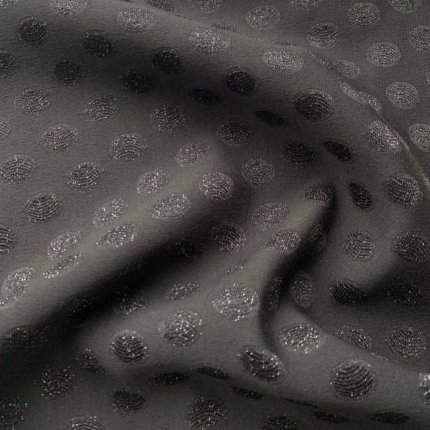 scramble displaying the black color version of a medium weight polyester blend featuring metallic spots with lurex thread