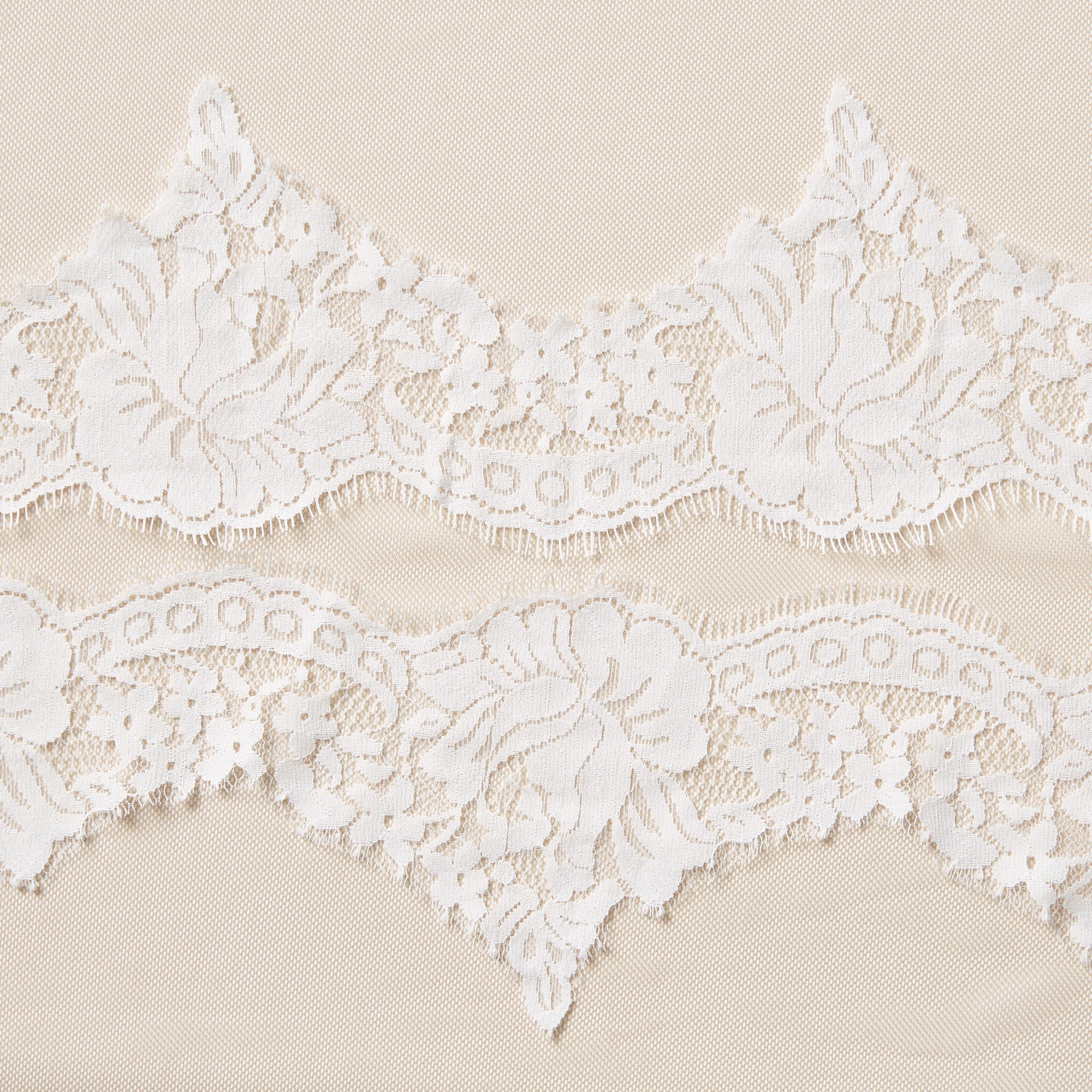 Displaying rose lace with the the trim Scalloped lace with eyelash trim on ivory colored pure nylon