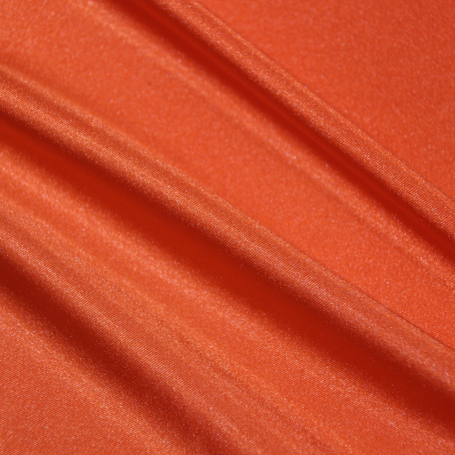 lola presenting the lava color version of a stretch light weight soft satin polyester with spandex
