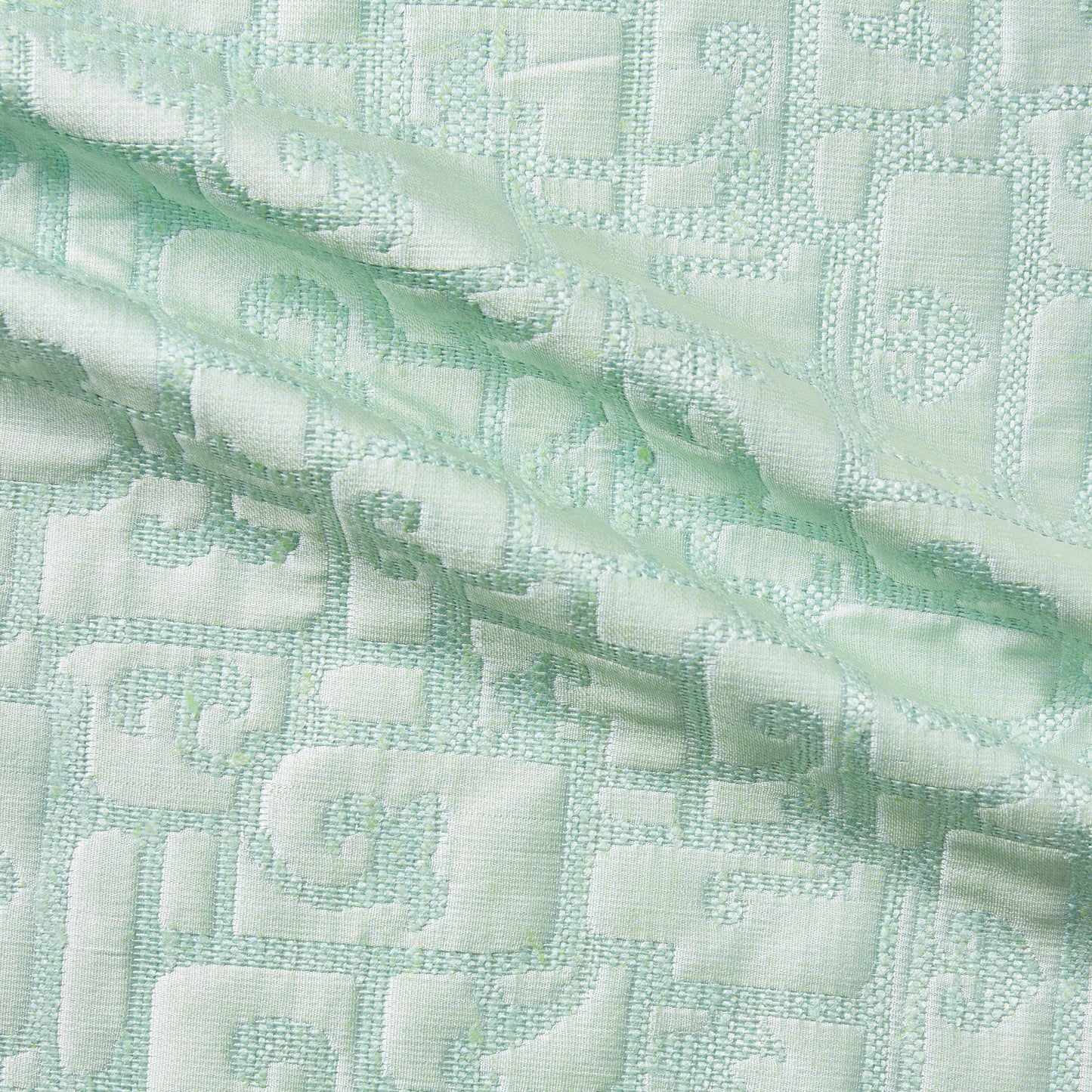 luxor dsiplaying the mint color version of a heavy weight pure silk brocade with abstract Egyptian styled pattern