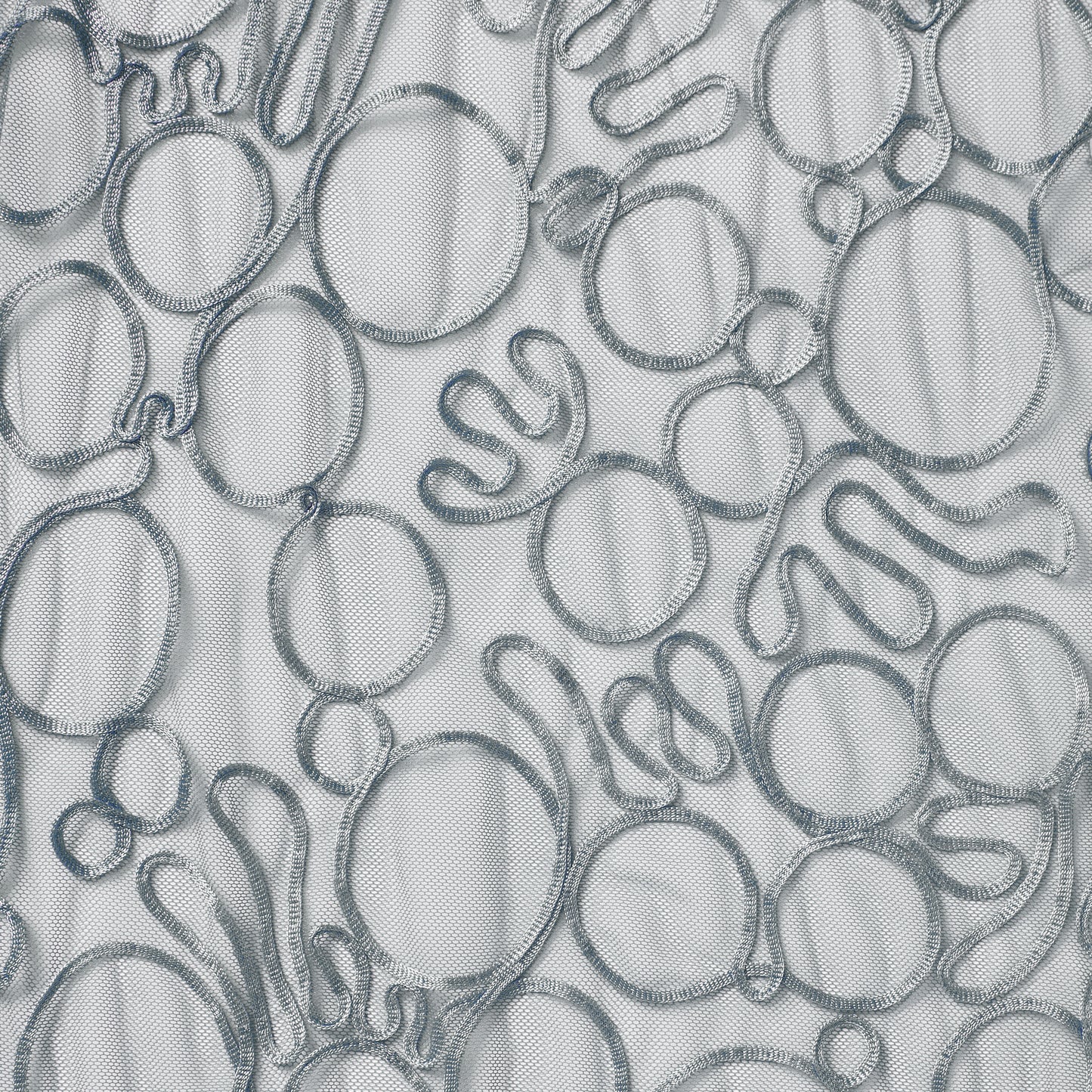 roulette presenting the silver color version of a polyester and rayon abstract circular Embroidery on fine sheer mesh