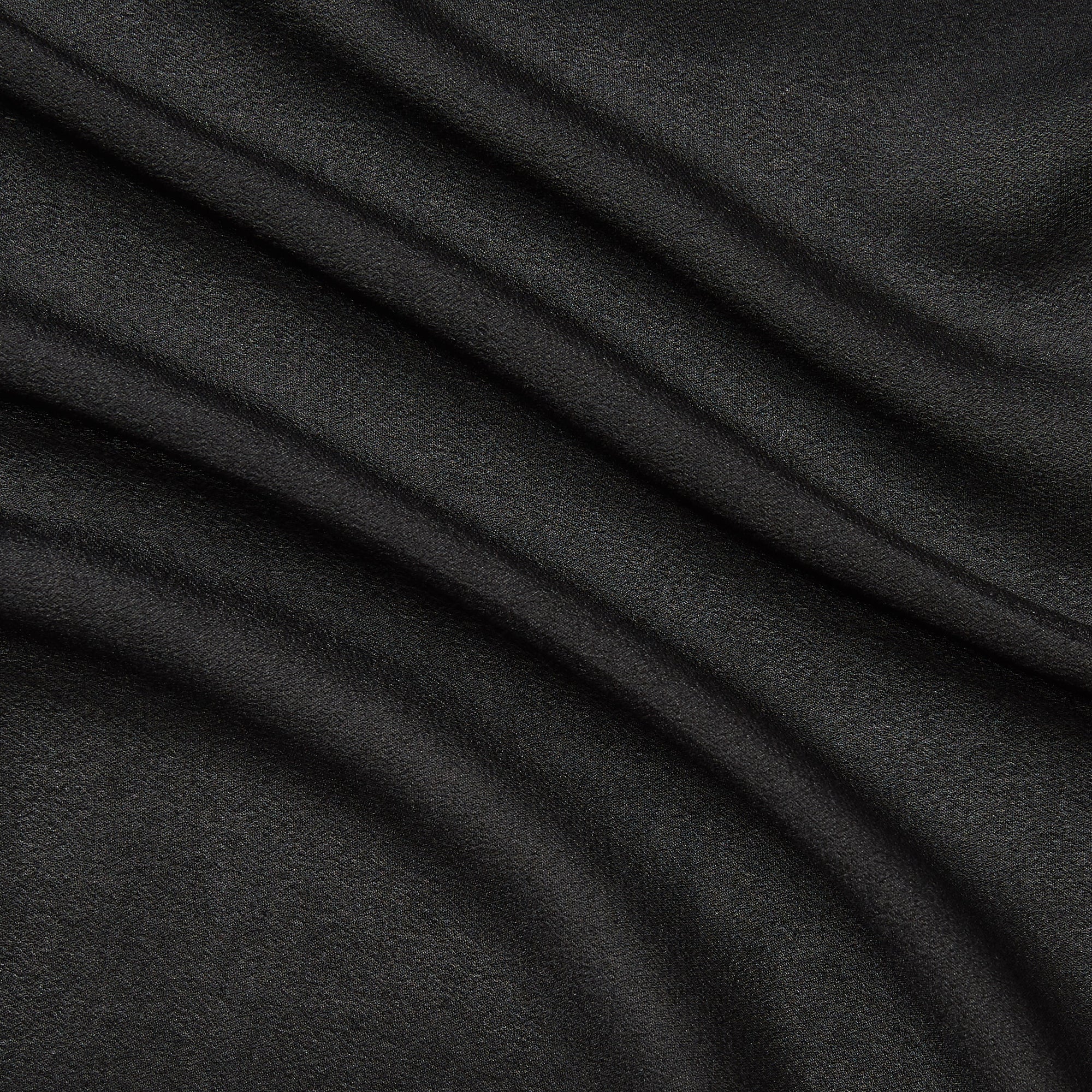 Illustrating shimmer a black colored fabric with metallic glitter print on Semi-sheer, soft pure silk georgette featuring good drape