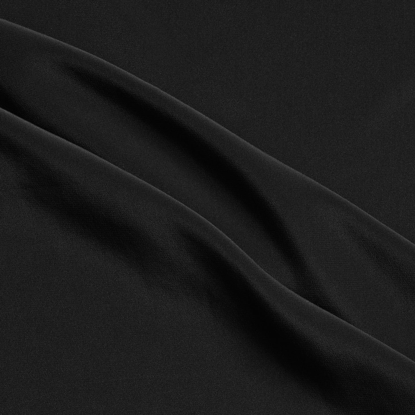 Crepe De Chine showing the Black color version of a Pure mulberry silk with fluid drape and a matte face and cool handle