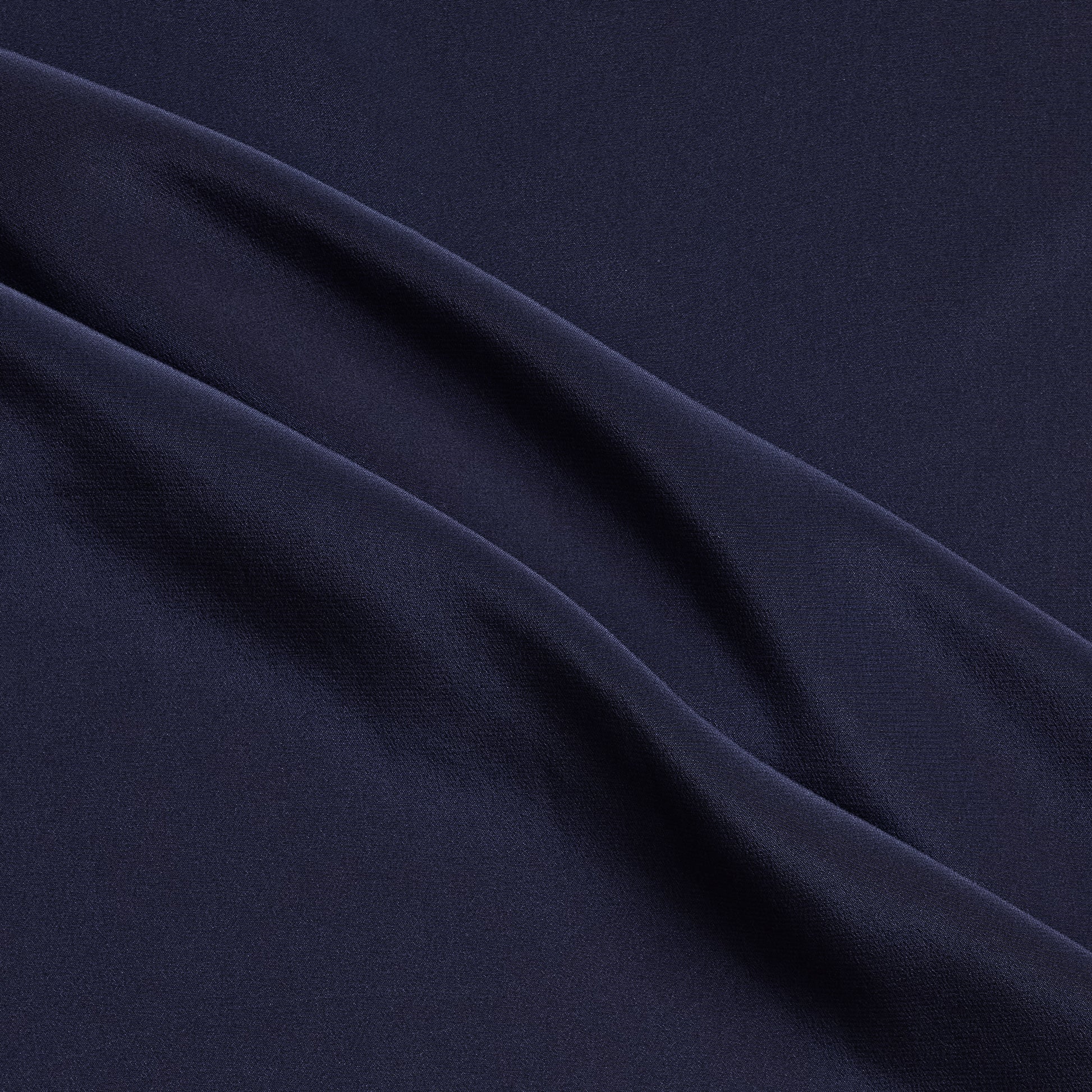 Crepe De Chine showing the Ink color version of a Pure mulberry silk with fluid drape and a matte face and cool handle