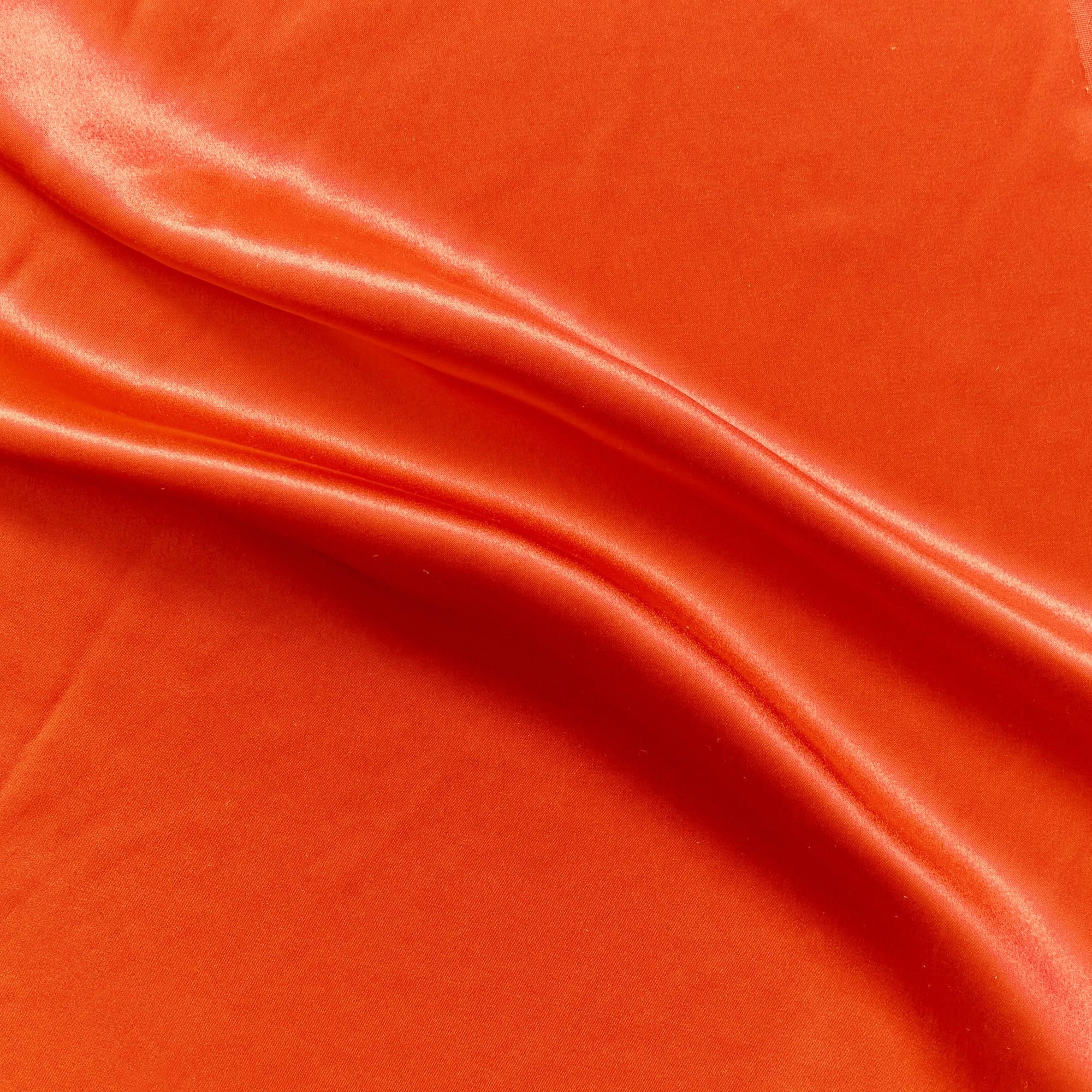 Silk Satin displaying the  lava color version of a soft pure mulberry silk satin with natural sheen and fluid drape