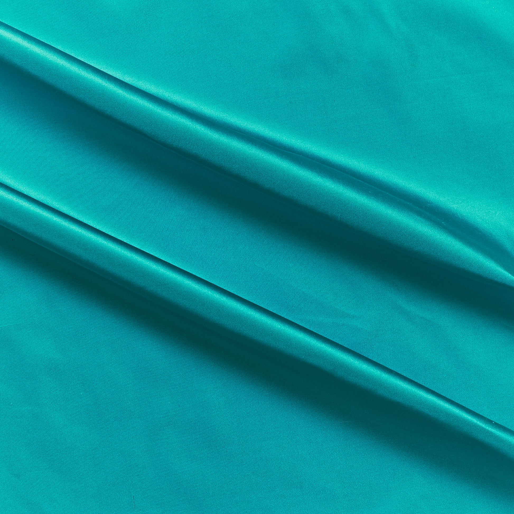 silk taffeta showing the turquoise color version of a smooth crisp pure silk with good drape