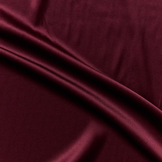 stretch silk satin displaying the ruby color version of a rich silk and lycra blend with great drape