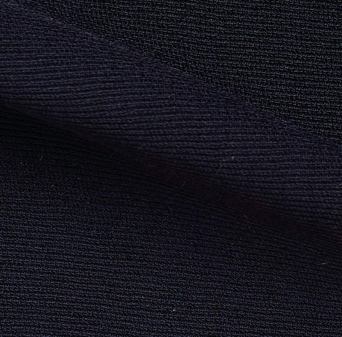 ultima displaying the navy color version of a polyester and acetate blend semi sheer mid weight textured fabric with fluid drape close up