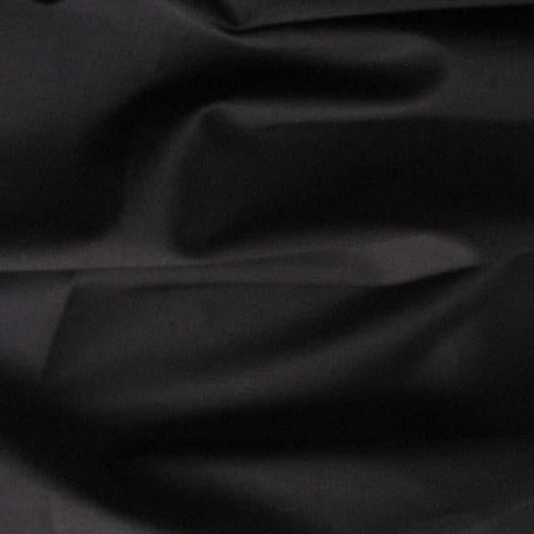 Displaying Sateen Cotton and Spandex a black colored Stretch Sateen with moderate drape Folds