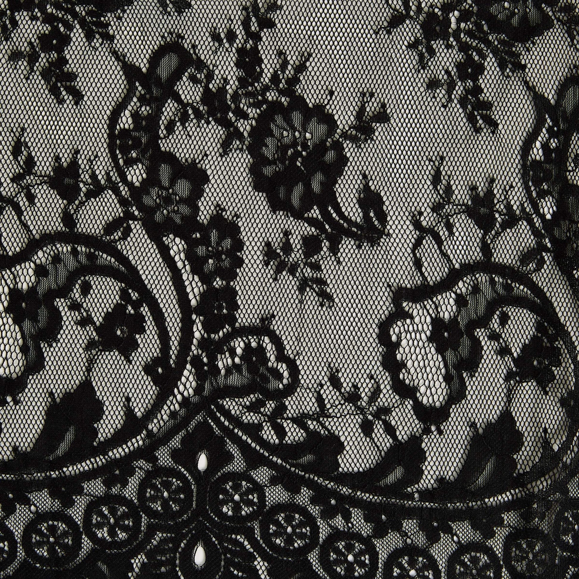 Featuring tivoli the black color version of an antique panelled lace with eyelash detailing on a nylon, rayon and cotton blend with metallic print